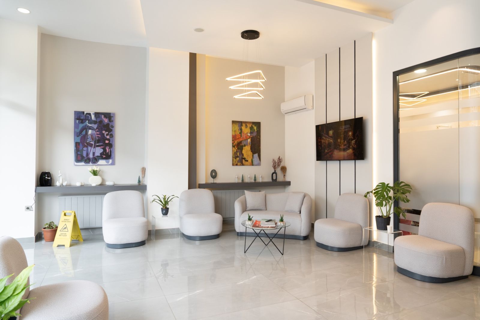 The waiting lounge at TORA Clinic, with soft seating and artwork.
