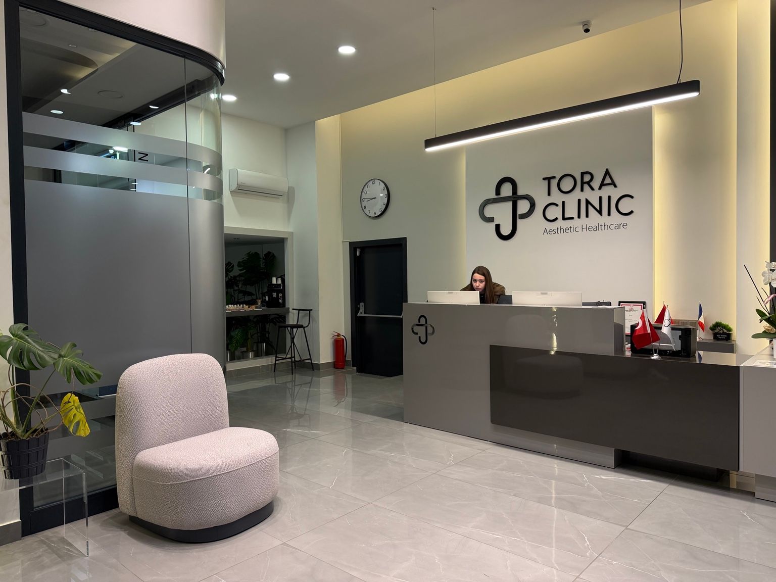 The reception at TORA Clinic, with the clinic logo on the wall.