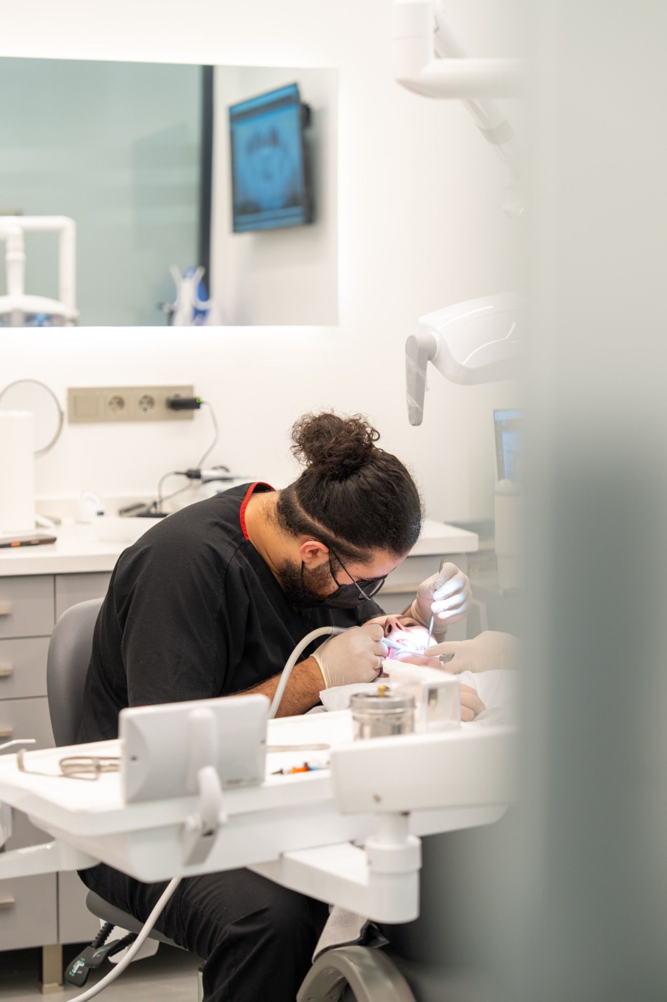 A dentist at work at the treatment chair.