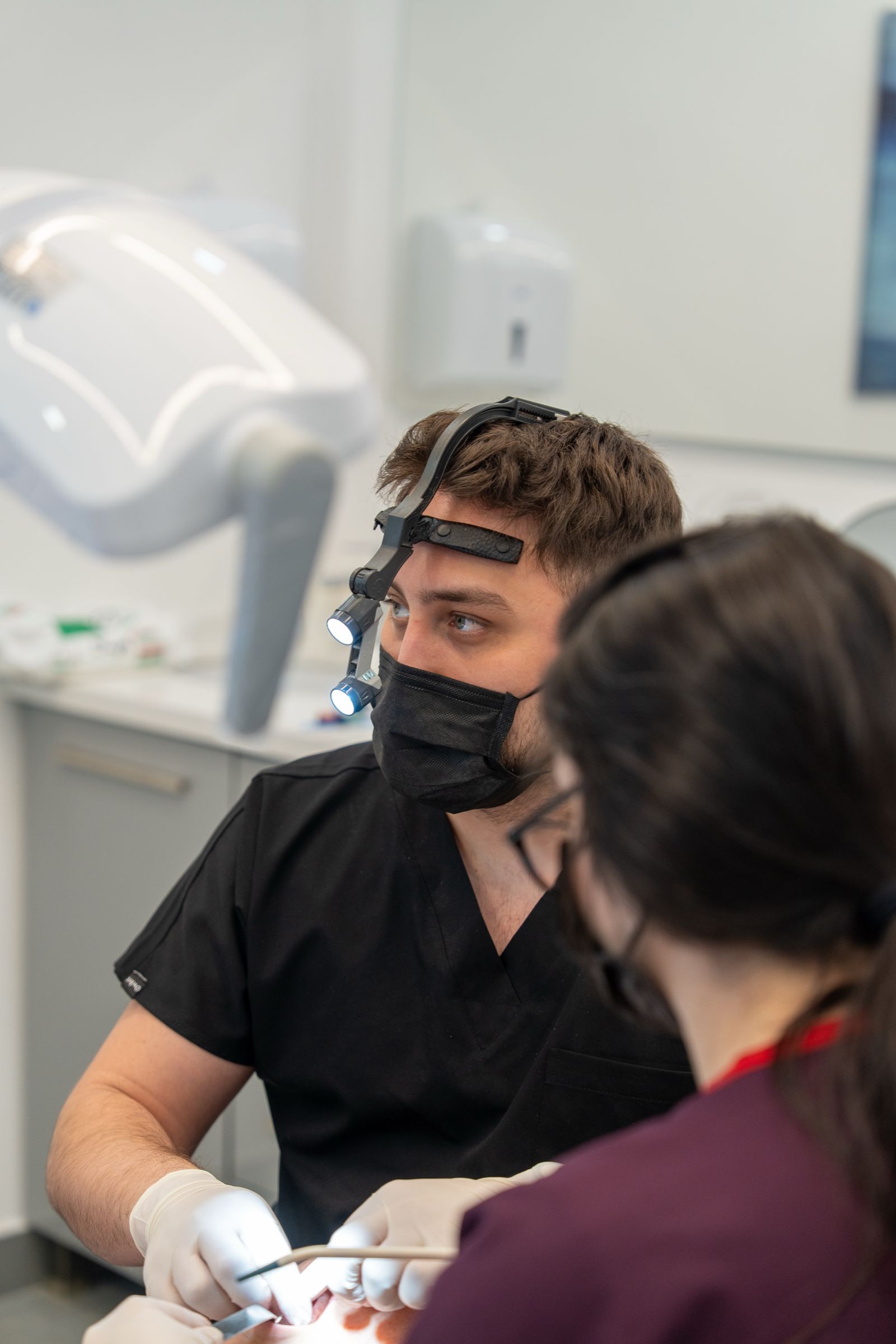 A dentist and a team member working together at the chair.